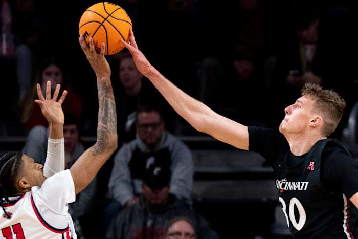 Cincinnati Bearcats forward Viktor Lakhin (30) blocks Detroit Mercy Titans forward Gerald Liddell (11) in the second half of the NCAA men s basketball game at Fifth Third Arena in Cincinnati on Wednesday, Dec. 21, 2022. Cincinnati Bearcats defeated Detroit Mercy Titans 72-54. Ncaa Basketball Detroit Mercy Titans At Cincinnati Bearcats